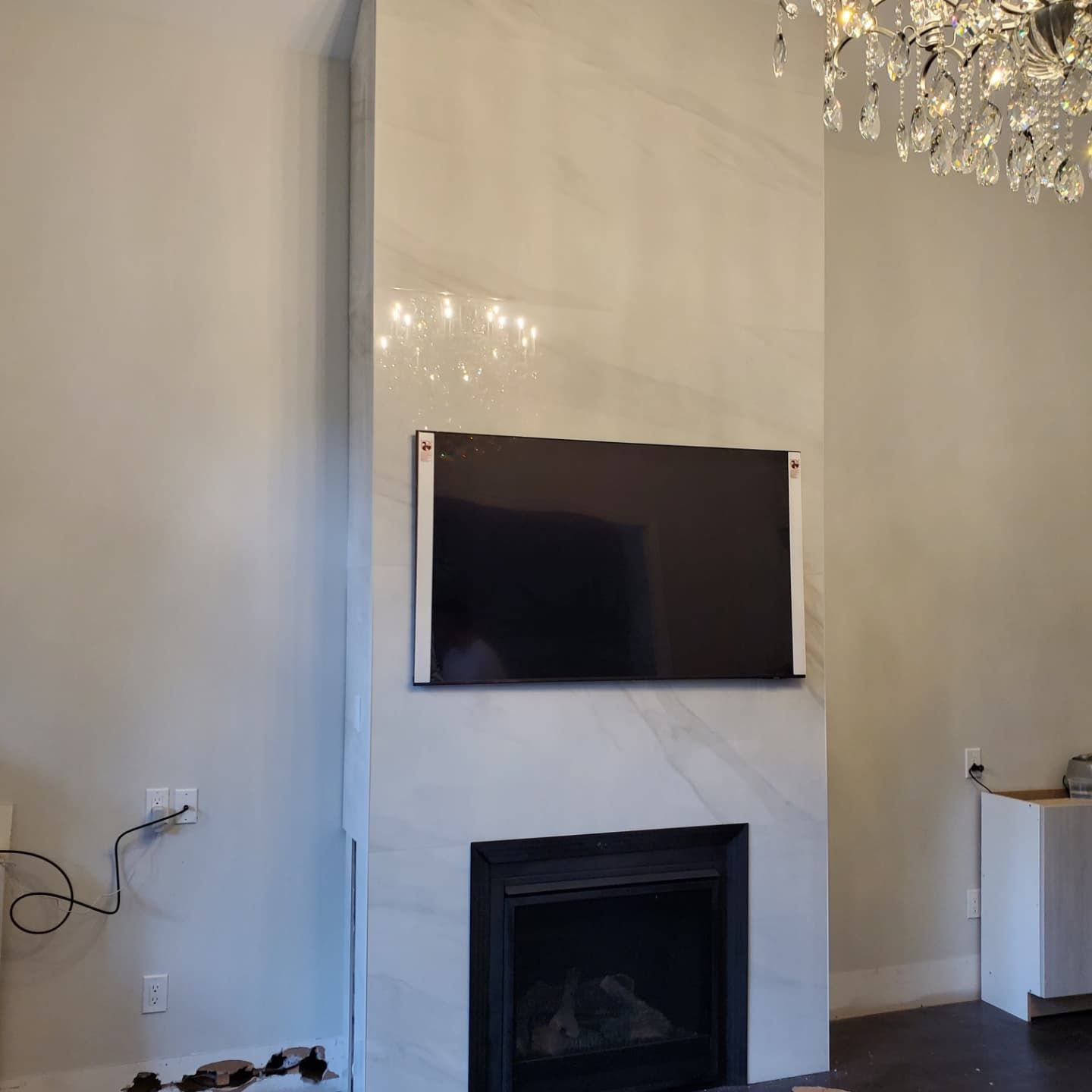 A living room with a fireplace and a flat screen tv