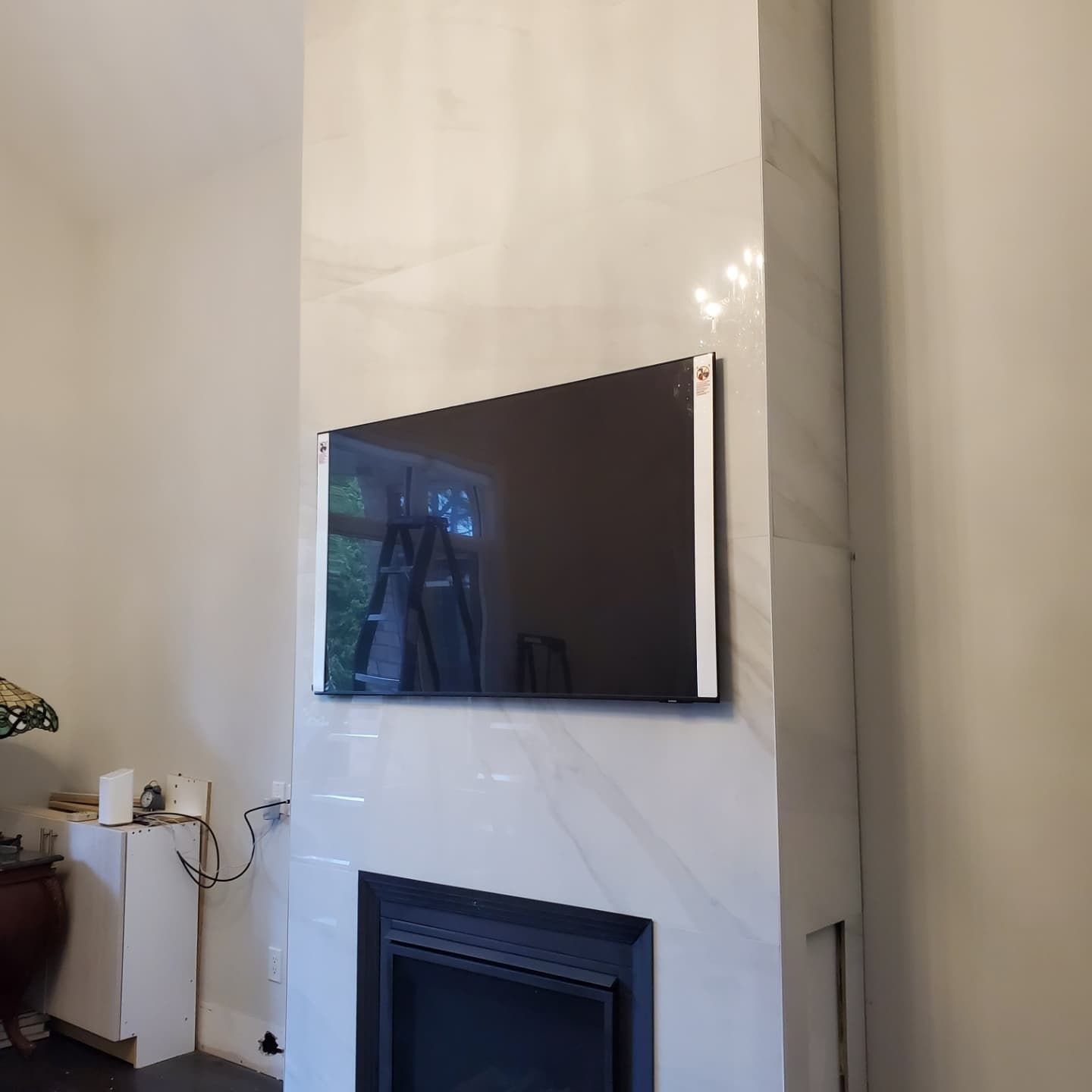 A living room with a fireplace and a flat screen tv