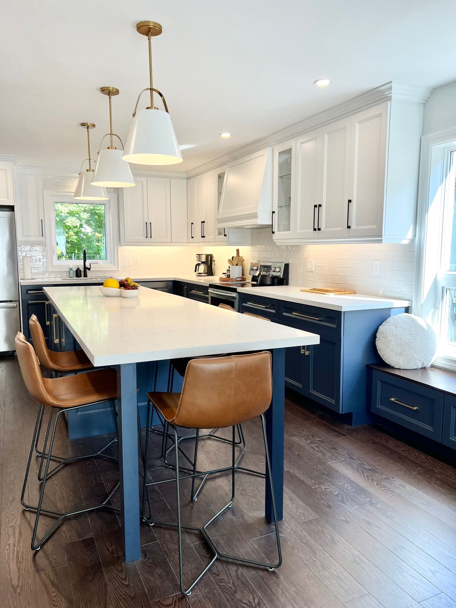 A kitchen with a long table and chairs in it.