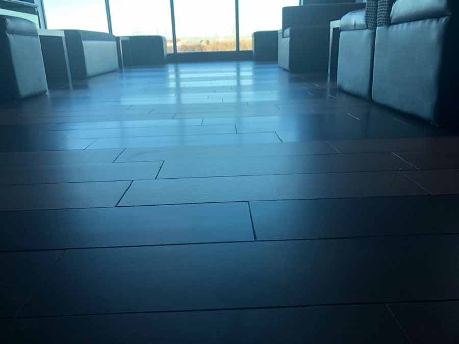 A living room with hardwood floors and a large window.