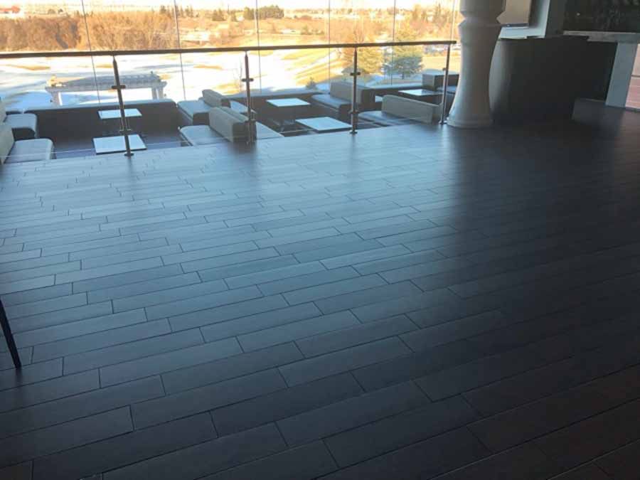 A room with a wooden floor and a glass railing.