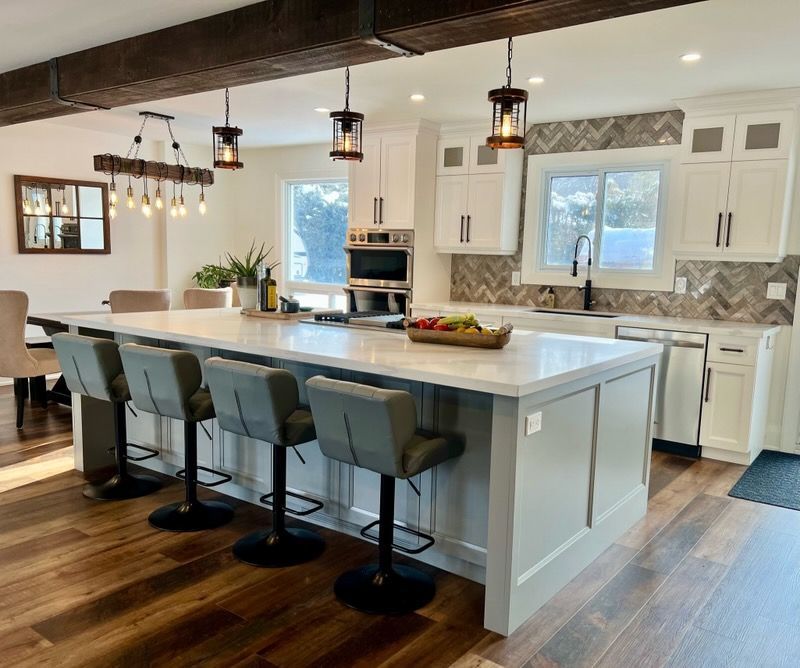 A kitchen with a large island and stools
