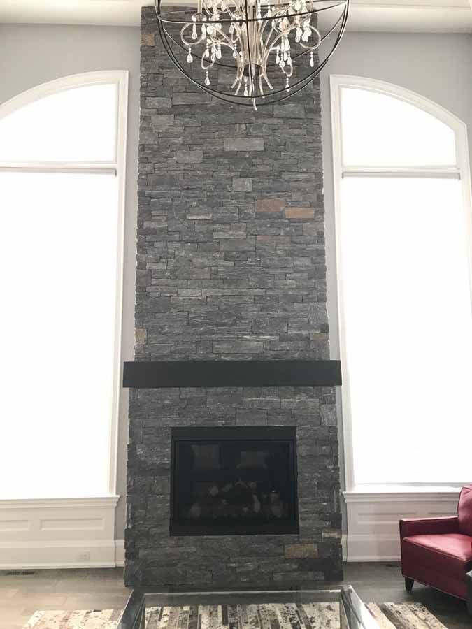 A living room with a fireplace and a chandelier.