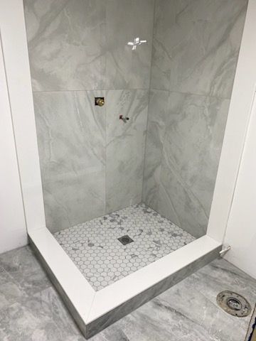 A bathroom with a walk in shower and a toilet.