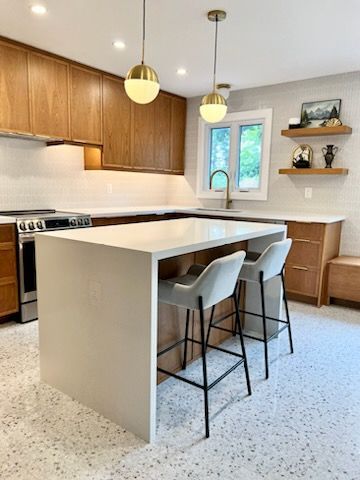 There is a large island in the middle of the kitchen.