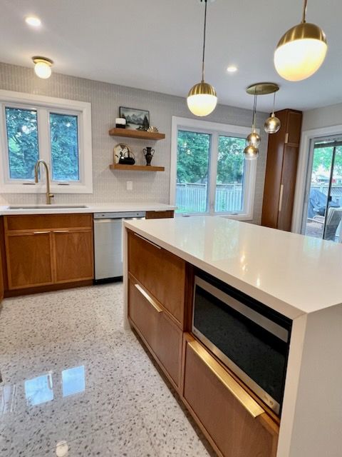 A kitchen with a large island and wooden cabinets
