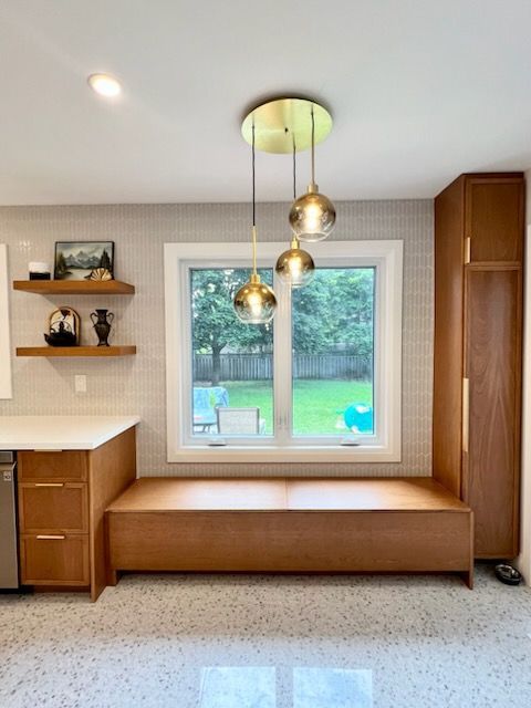 A kitchen with a window and a bench in front of it