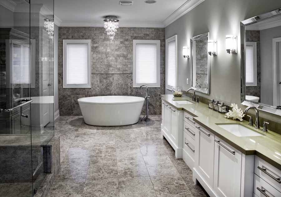 A bathroom with a tub , sinks , mirrors and a walk in shower.