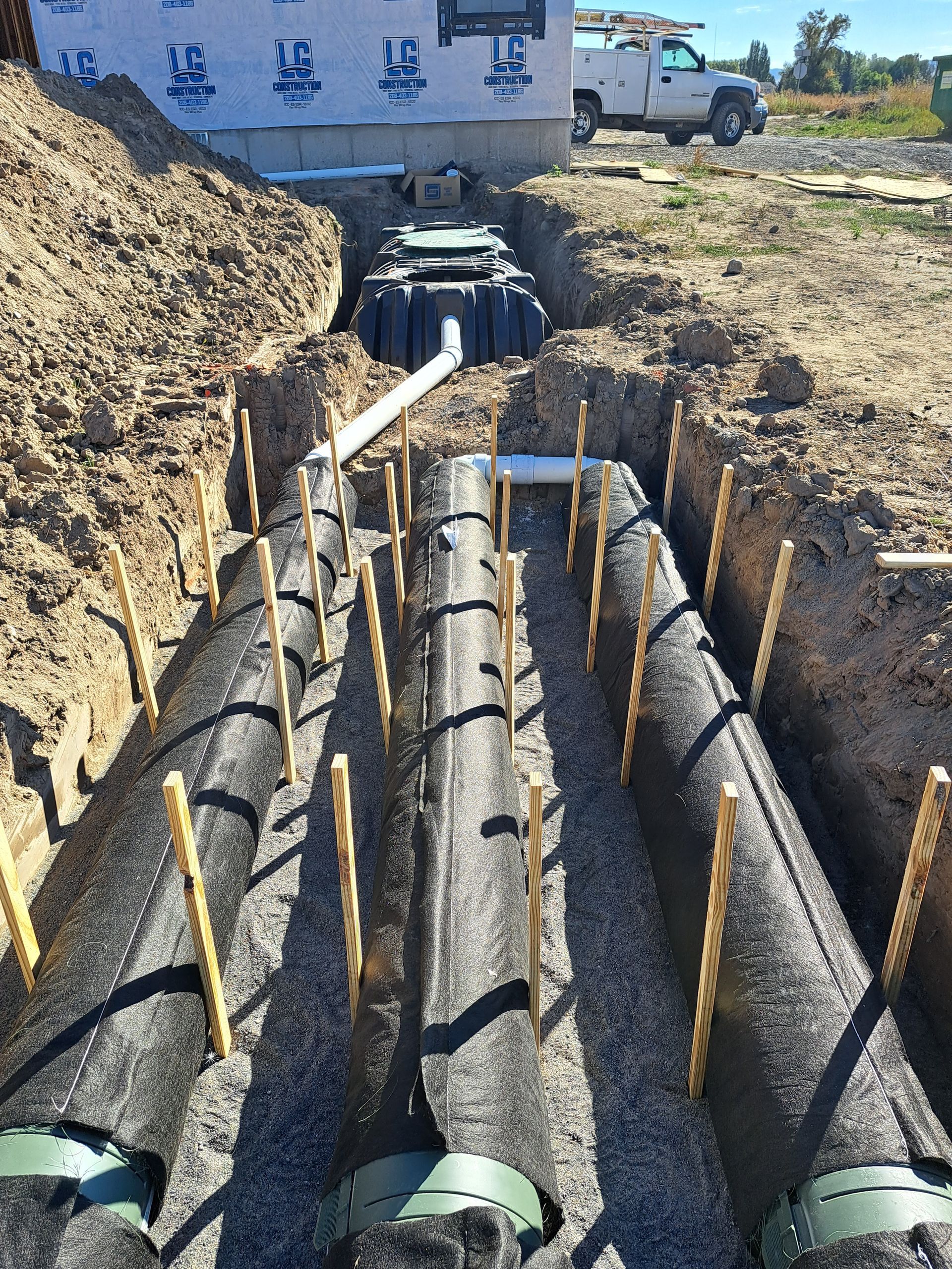 A septic system is being installed in a hole in the ground.