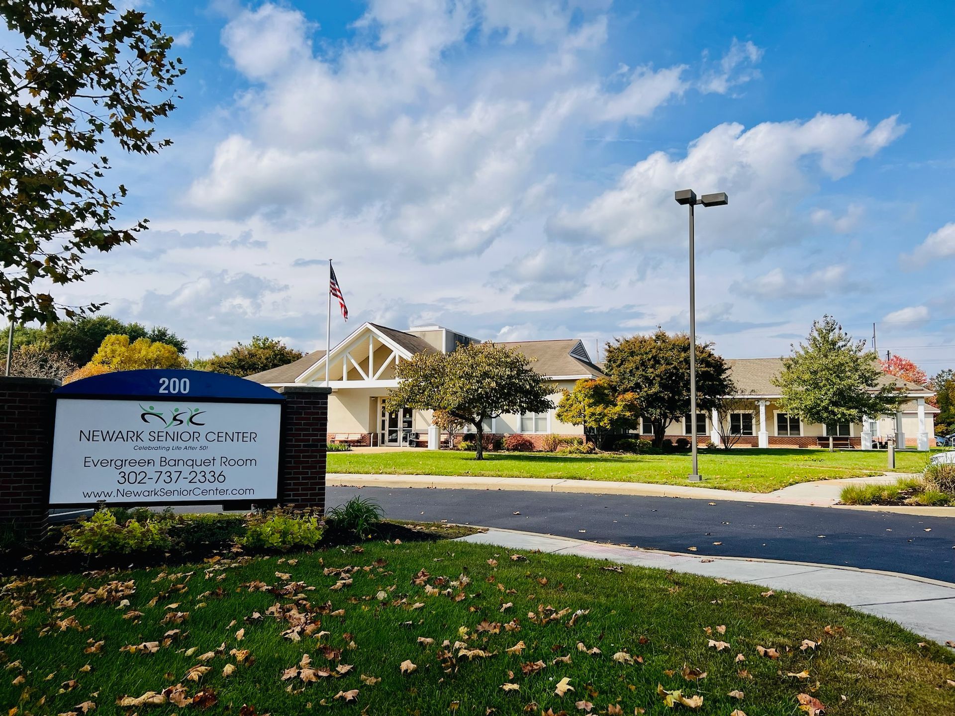 A sign for the Monroe County District Attorney’s Office in front of a one-story building under a blue sky.