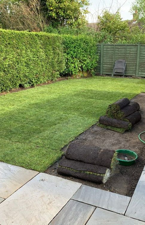 Rolls of Turf Are Sitting on the Ground in a Backyard — Ballina Turf Farm in Ocean Shores, NSW
