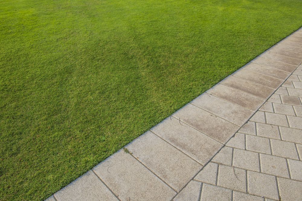 A Brick Walkway Next to a Lush Green Lawn — Ballina Turf Farm in Lismore, NSW