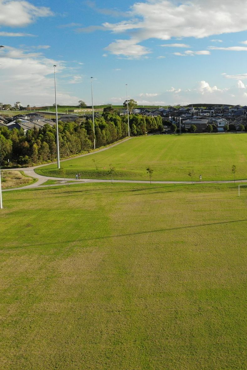 An Aerial View of a Lush Green Field With Trees in the Background — Ballina Turf Farm in Lismore, NSW