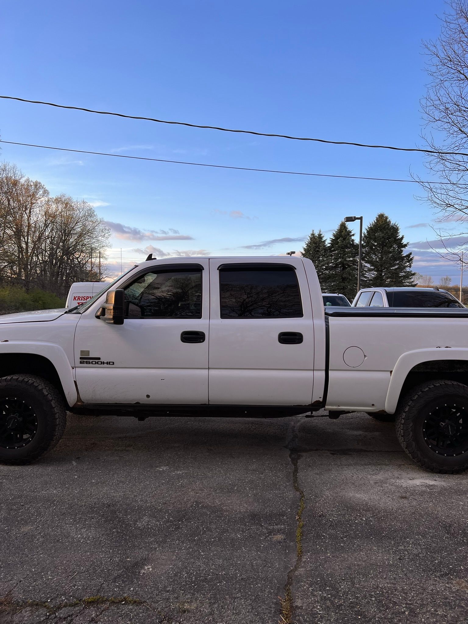A white truck is parked on the side of the road.