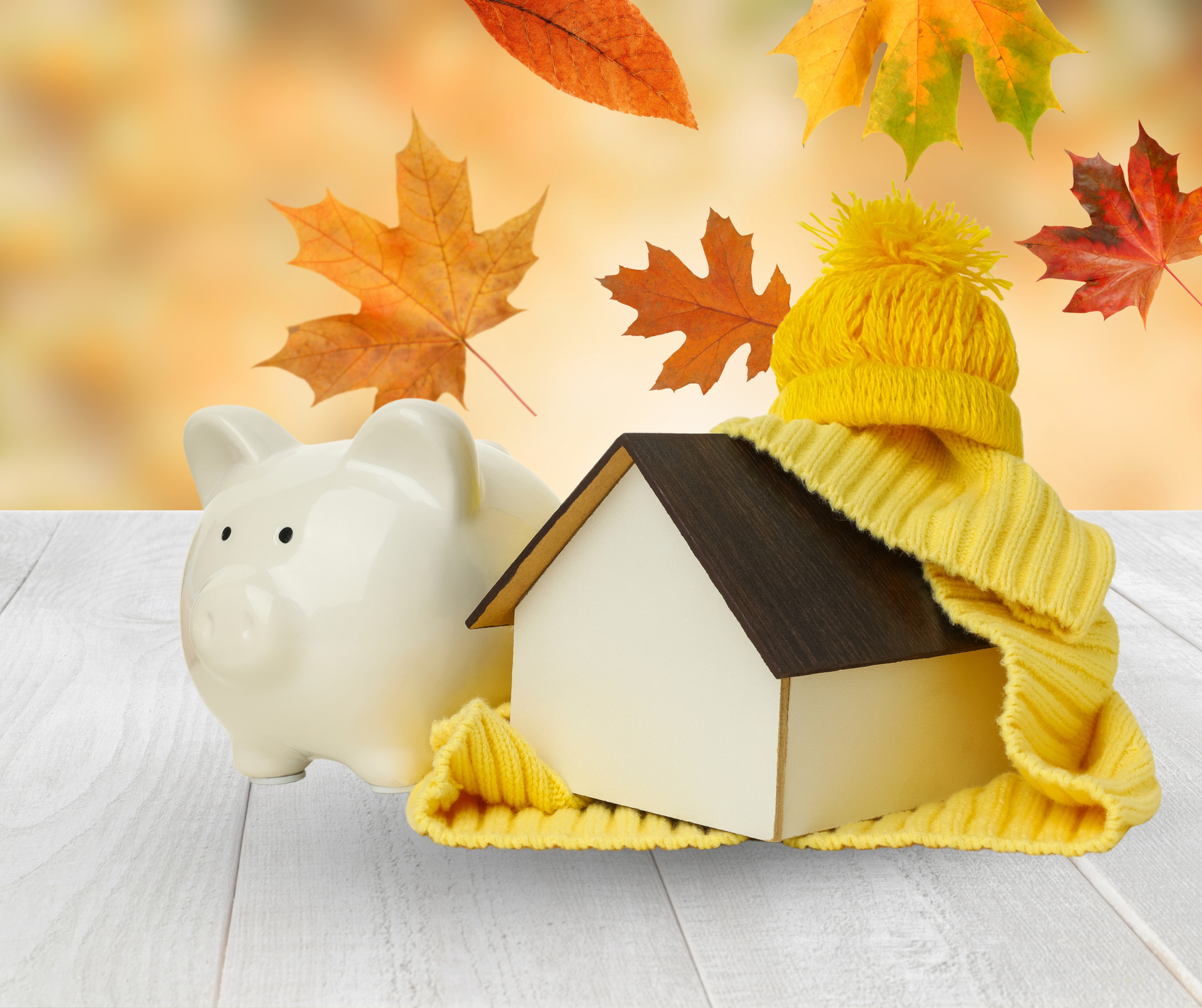 Home surrounded by colorful fall trees symbolizing rising energy bills as temperatures drop.