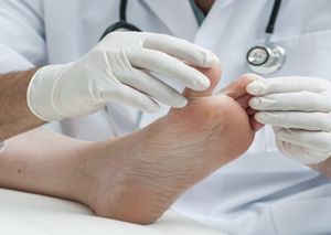 podiatrist spreading toes for diabetic foot care in Niagara Falls, NY
