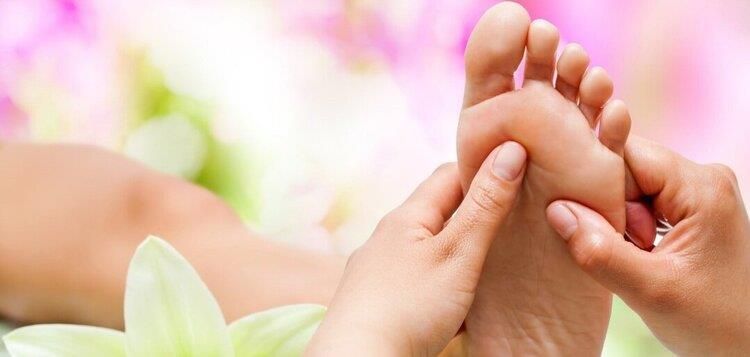 A woman is getting a foot massage in a spa.