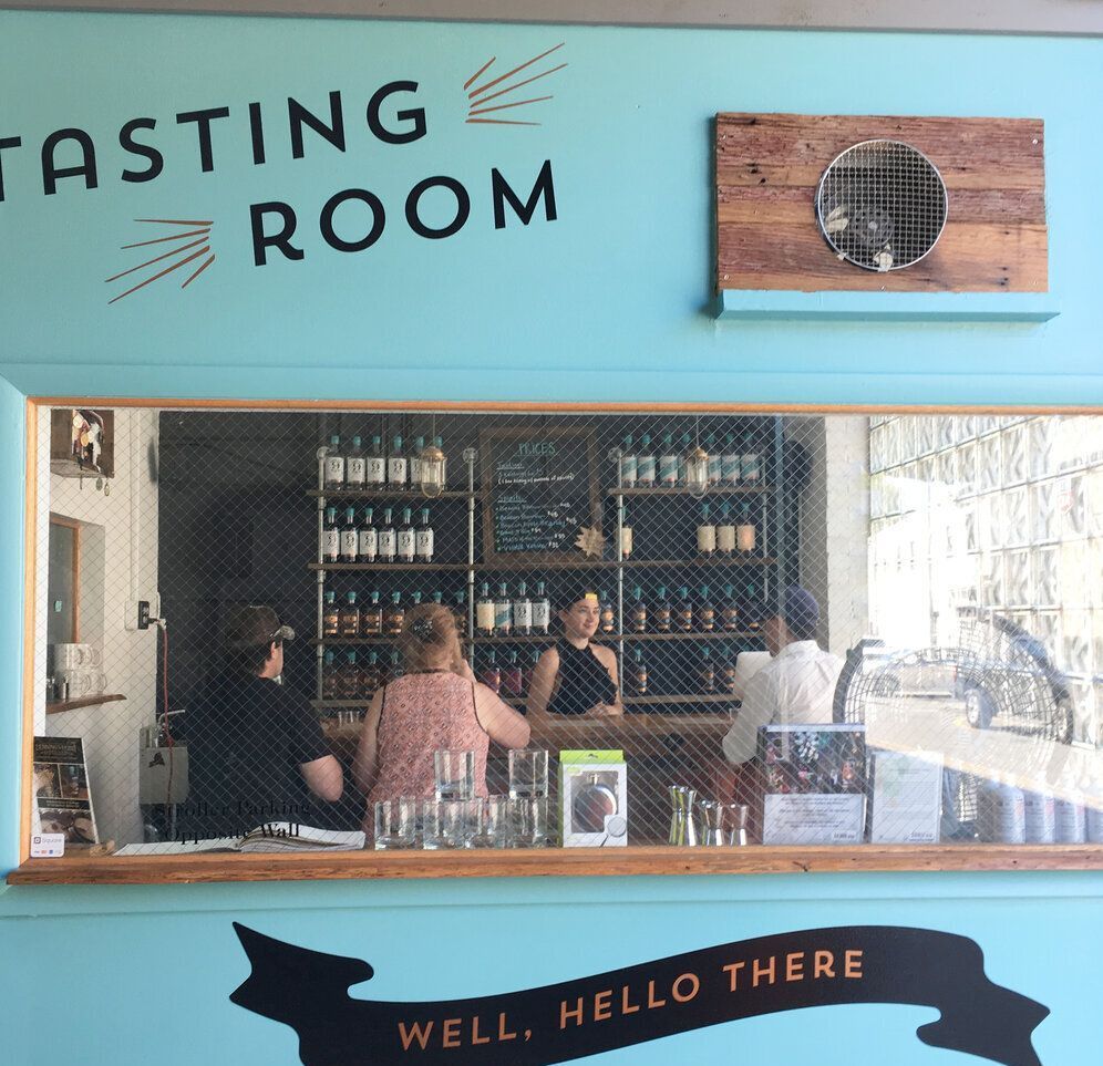 A tasting room with a sign that says well hello there.