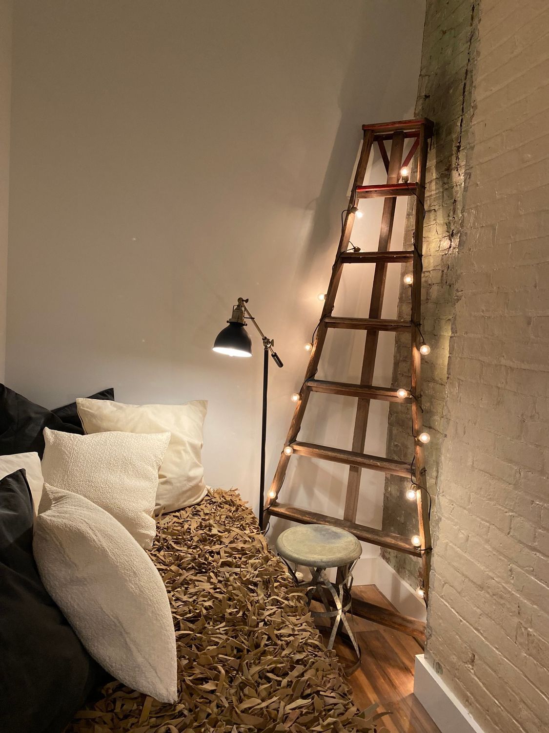 A bedroom with a bed and red lanterns hanging from the ceiling