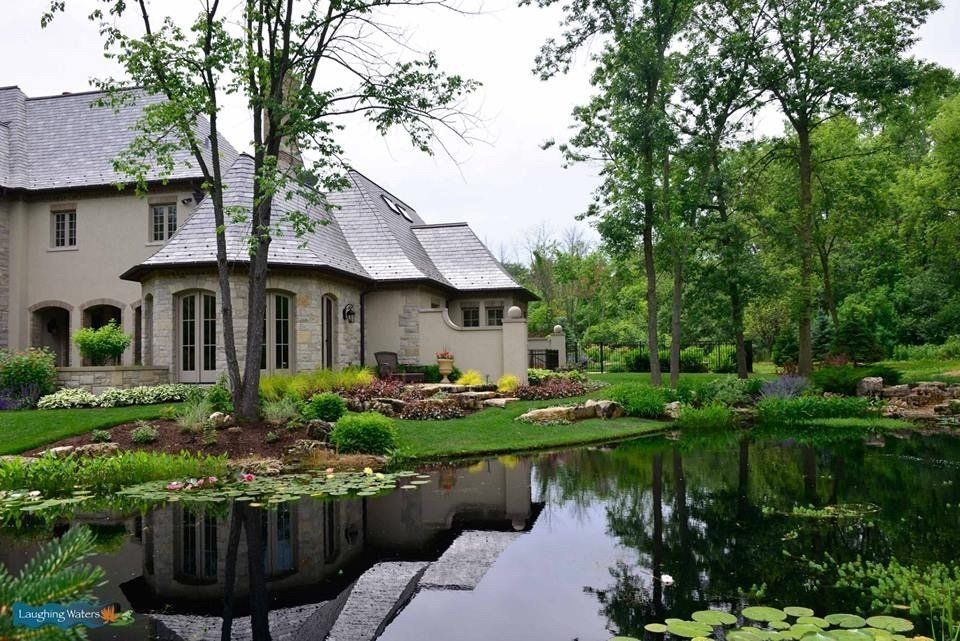 A large house with a pond in front of it