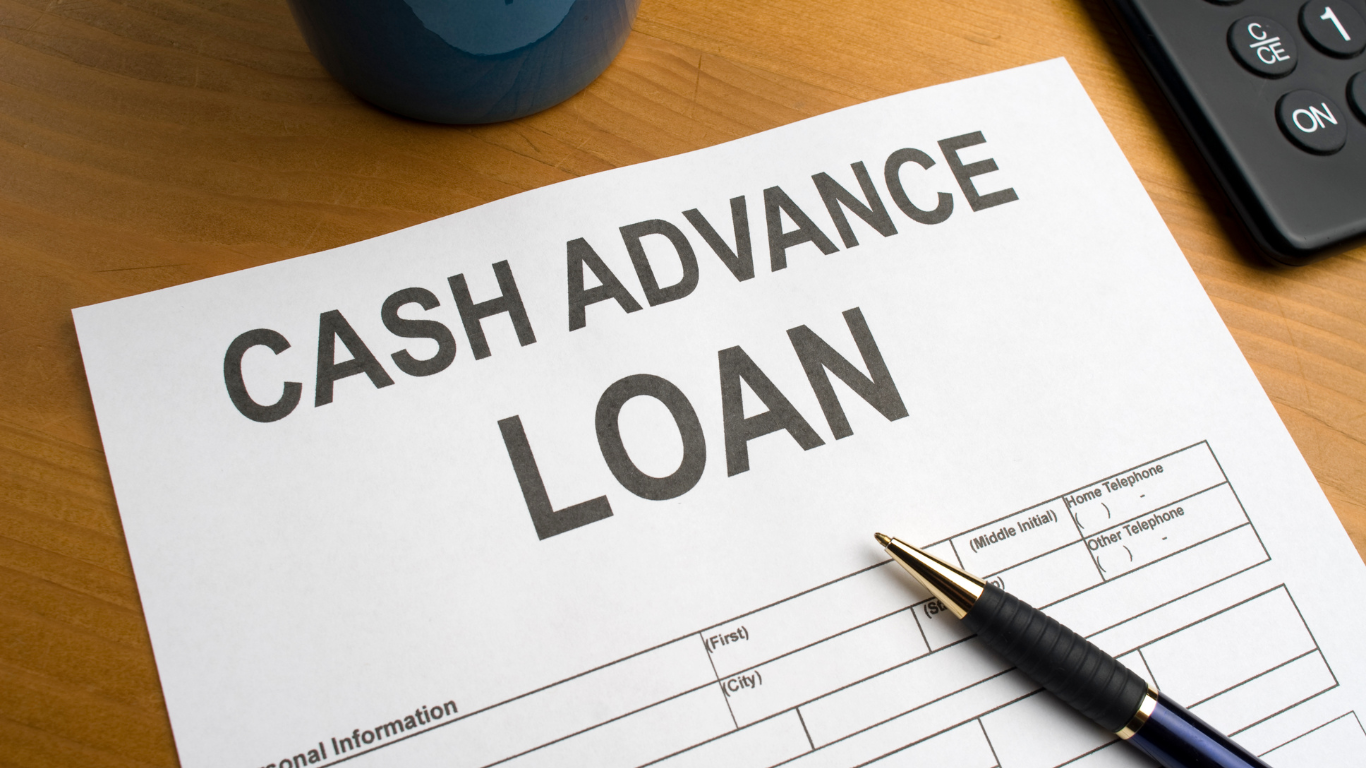 A pen sits on top of a cash advance loan form