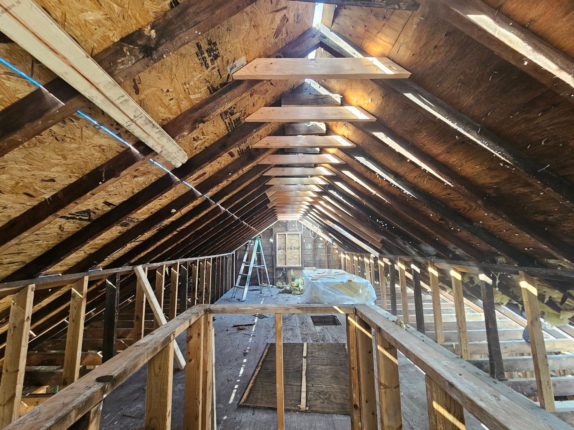 Interior view of an unfinished attic space with exposed wood framing.