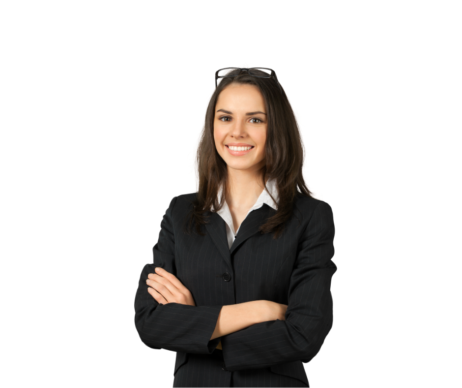 A woman in a suit and glasses is standing with her arms crossed and smiling.
