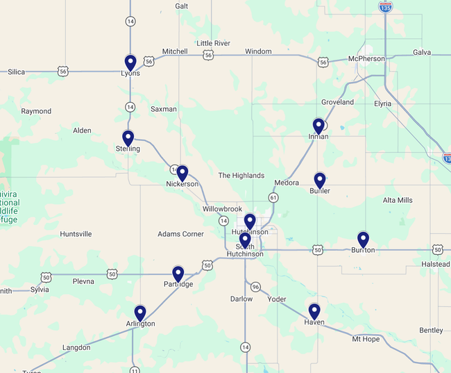 Map with several blue location pins marking sites around a city and surrounding roads.