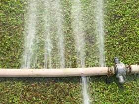 Sprinkler watering lawn in garden - Sprinkler Winterization In Lewiston, ID