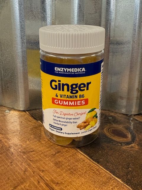 Jar of Enzymedica Ginger & Vitamin B6 gummies on a wooden surface.
