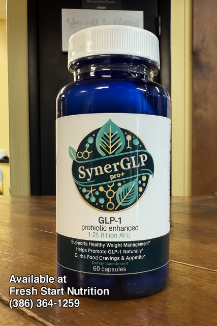 Blue bottle of SynerGLP dietary supplement with white label on a wooden table.