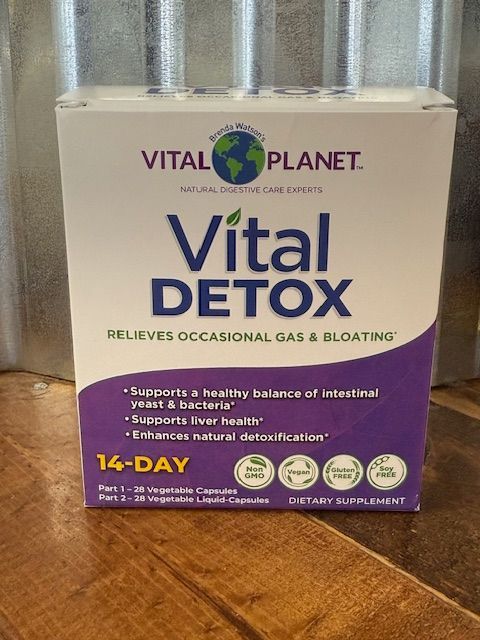 Box of Vital Planet Vital Detox supplement, purple and white label, 14-day supply, claims to relieve gas/bloating.