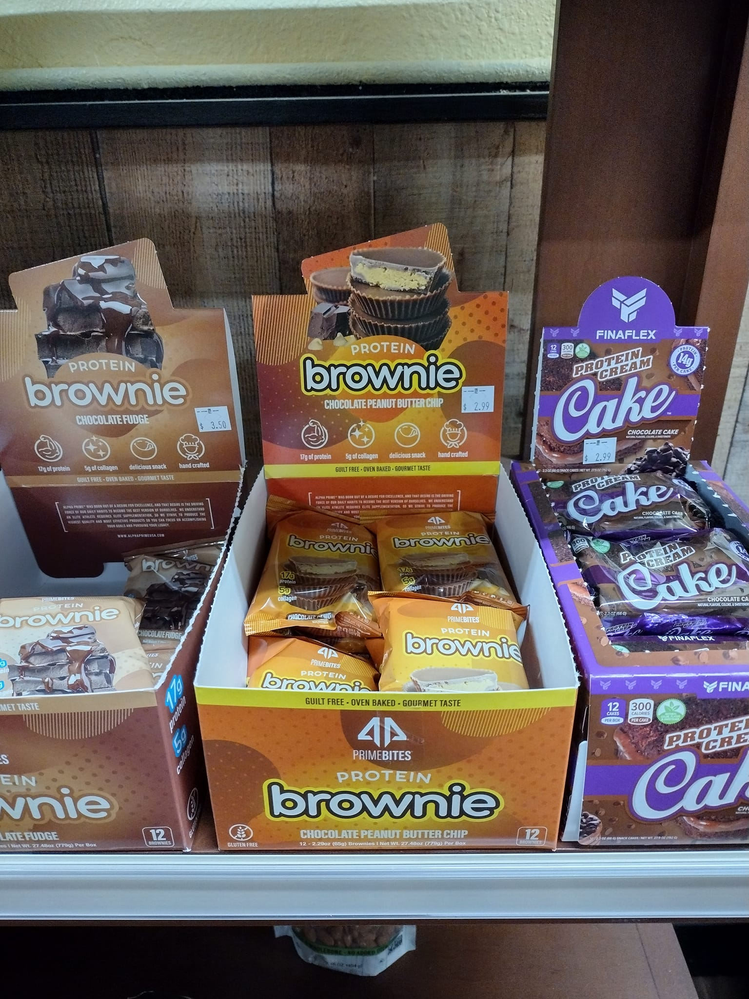 Shelves with brownie and cake snack bars in boxes.