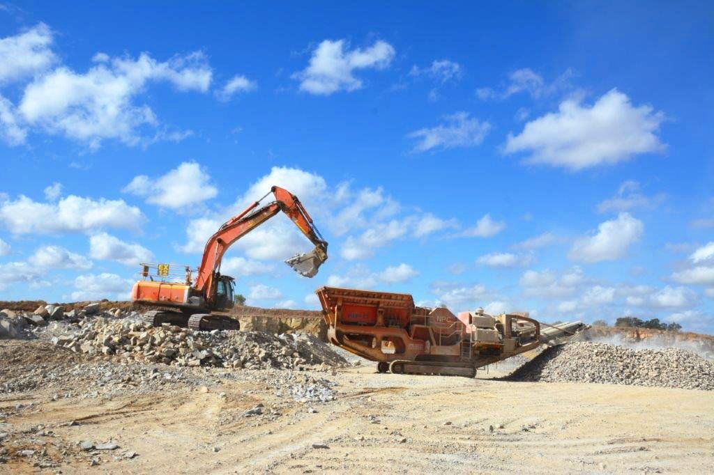 Orange Digger Loading Truck — Quarry Products In Moranbah, QLD