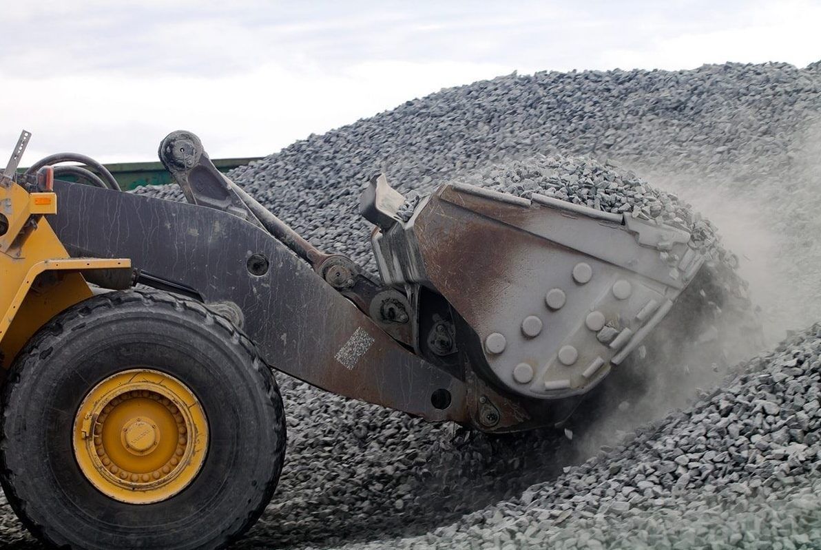 Excavator Bucking Scooping Gravel — Quarry Products In Moranbah, QLD