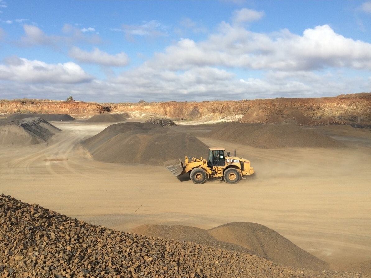 Excavator Driving Around Quarry — Quarry Products In Moranbah, QLD