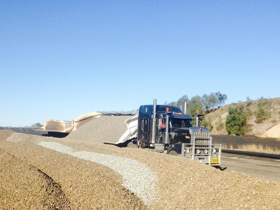 Truck Tipping Rock Onto The Side Of The Road — Quarry Products In Moranbah, QLD