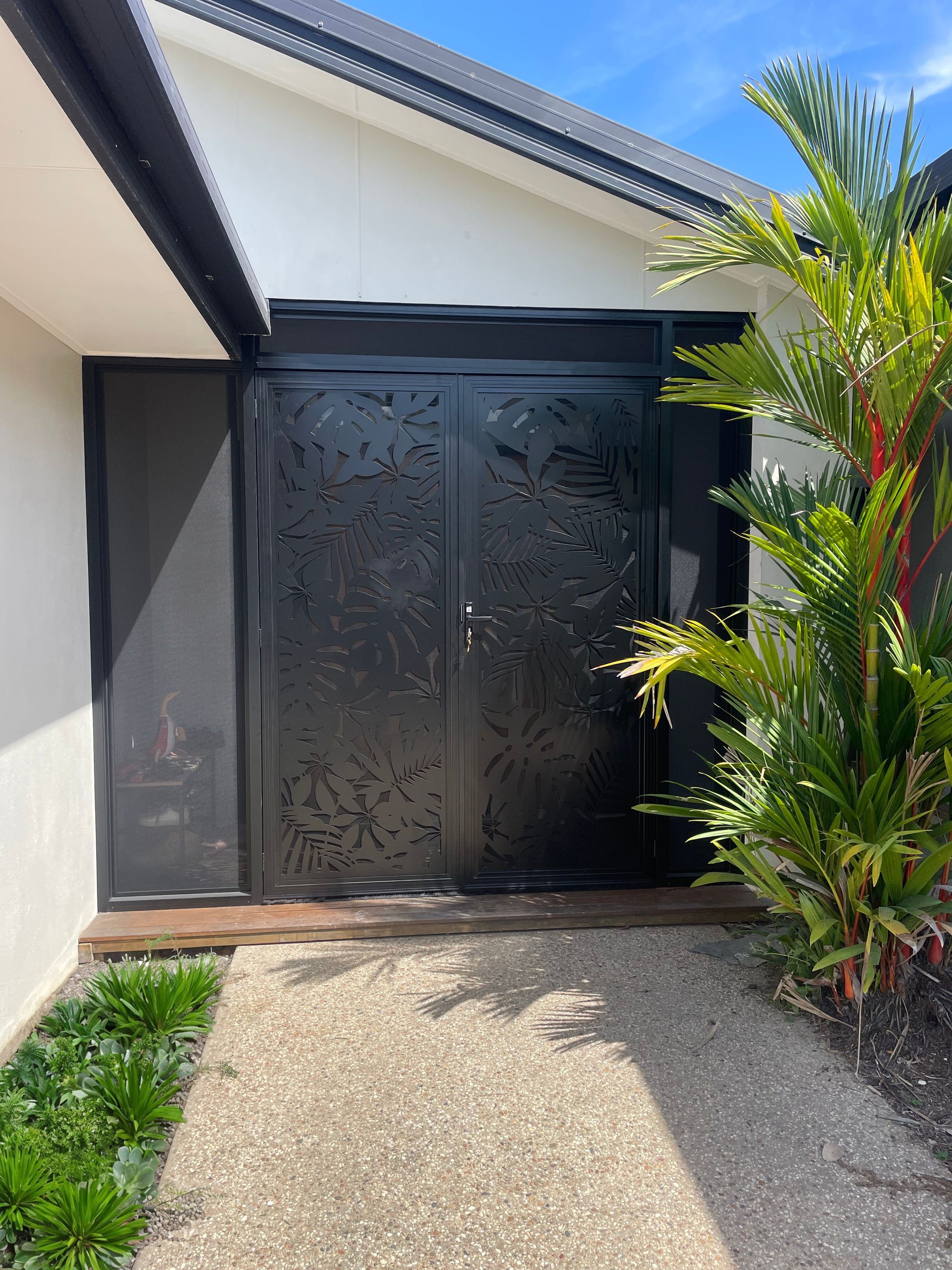 Black Patterned Metal Double Doors on a Home's Entrance — A1 Security Screens Cairns In Edmonton, QLD