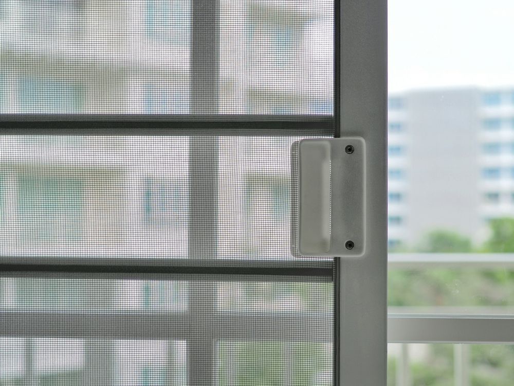 Close-up of a White Sliding Door Frame With a White Handle — A1 Security Screens Cairns In Edmonton, QLD