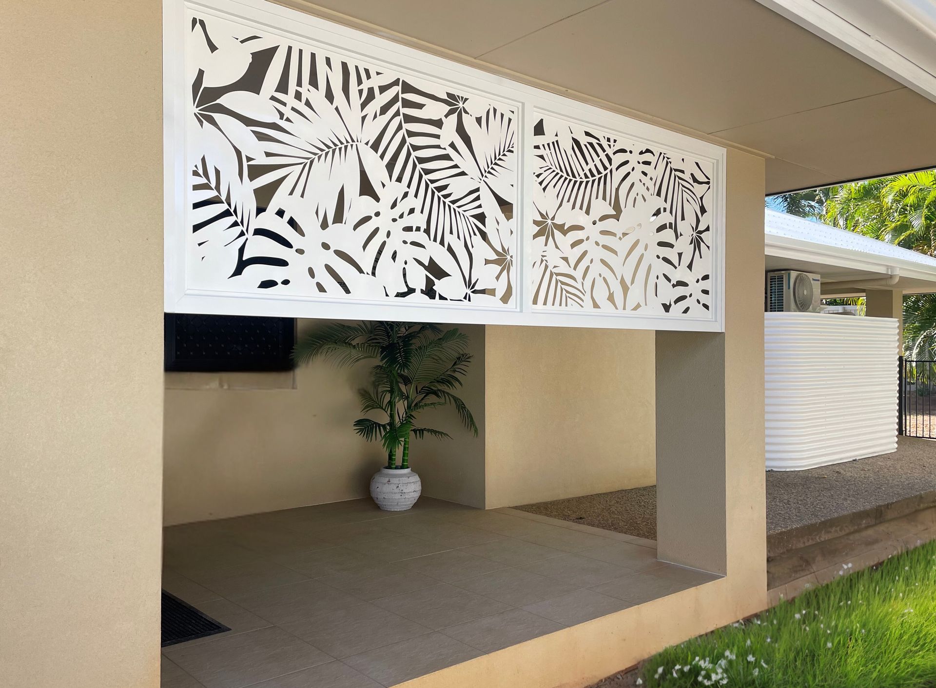 A House With a Gray Garage Door and a Balcony — A1 Security Screens Cairns In Manunda, QLD