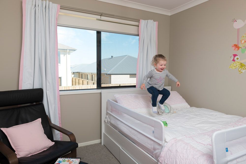 A White House With Three Windows and Flowers in Front of It — A1 Security Screens Cairns In Manunda, QLD