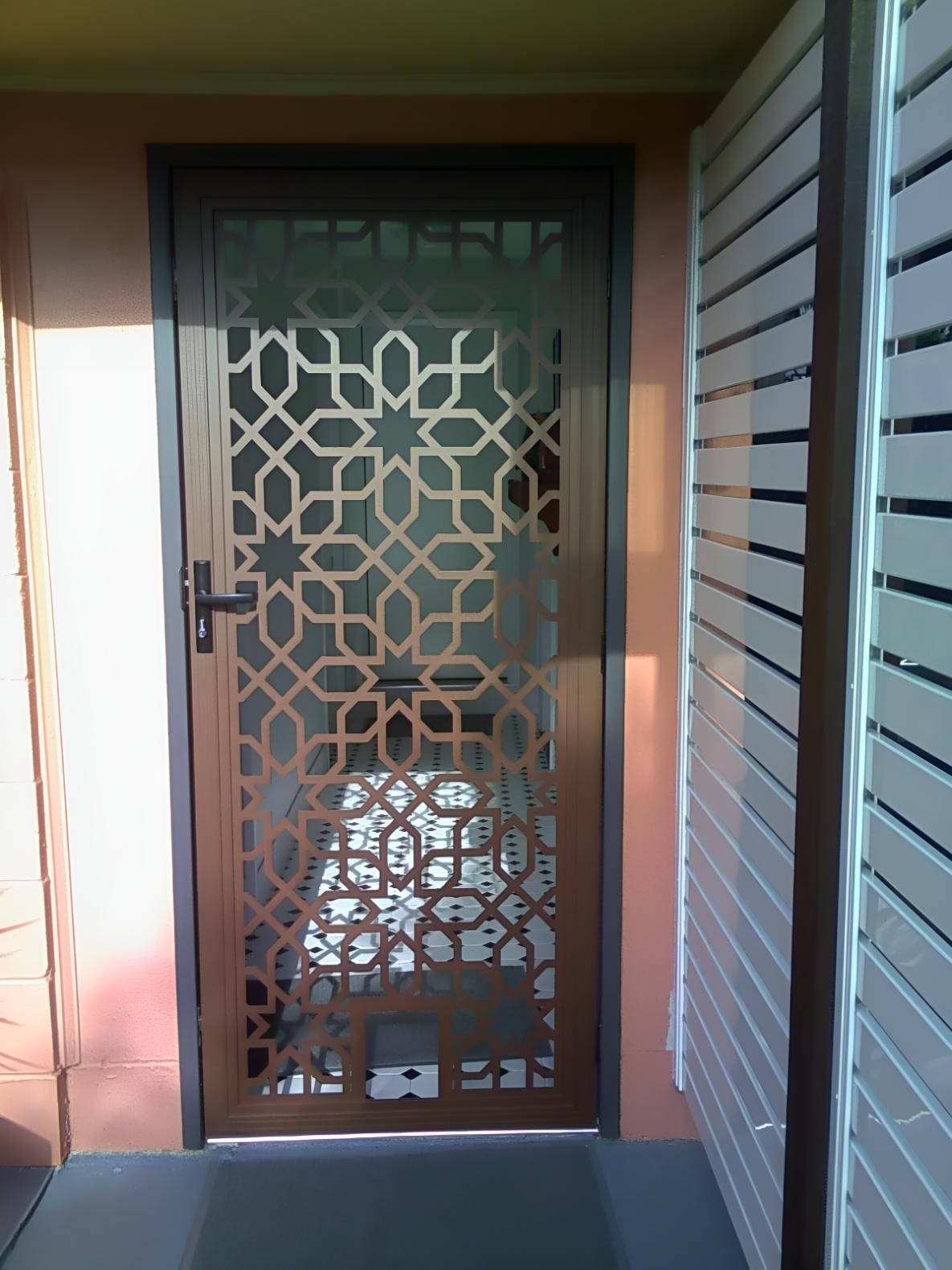 A Door With a Geometric Pattern on It — A1 Security Screens Cairns In Manunda, QLD