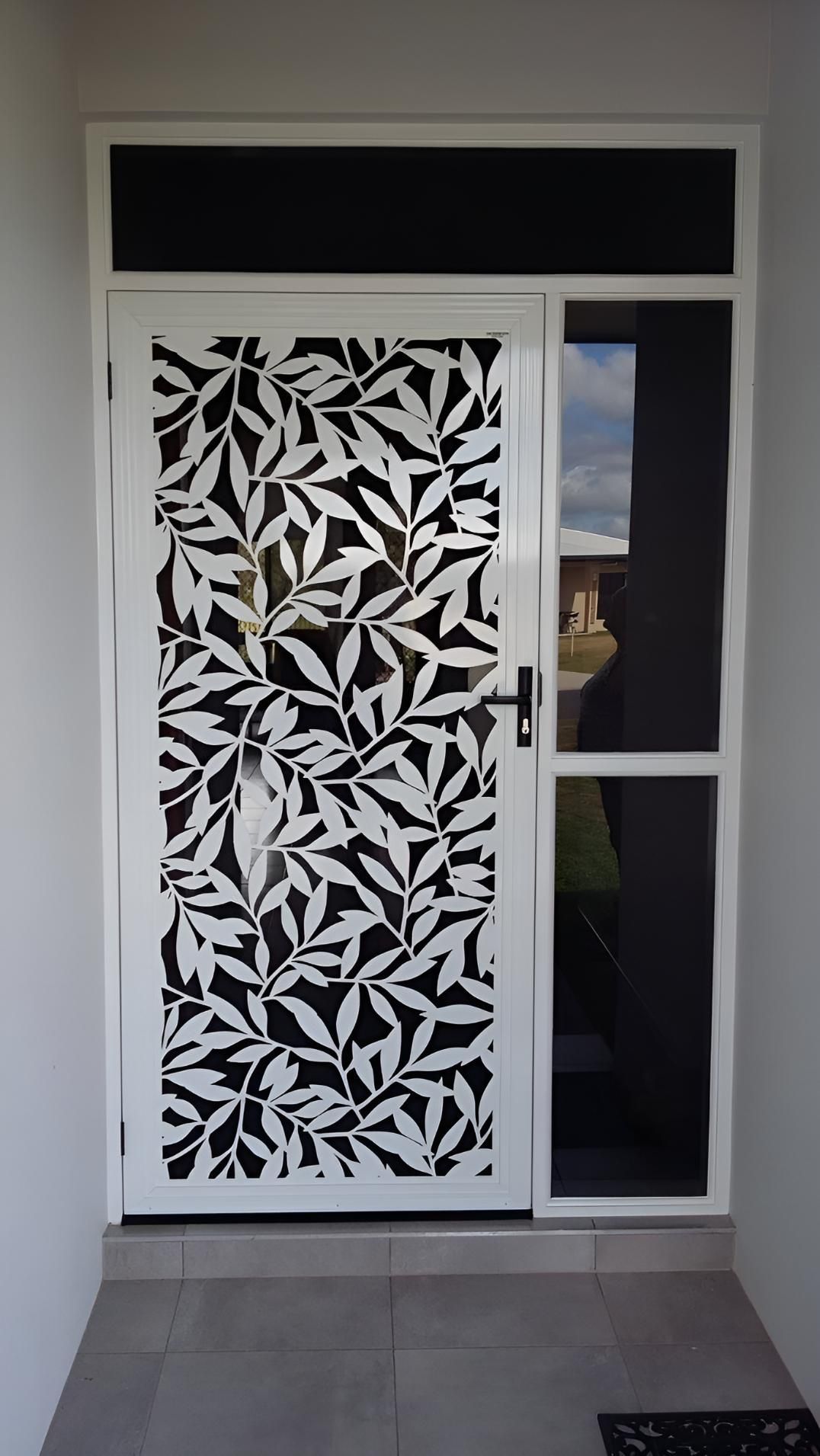 A White Door With a Black and White Design on It — A1 Security Screens Cairns In Manunda, QLD