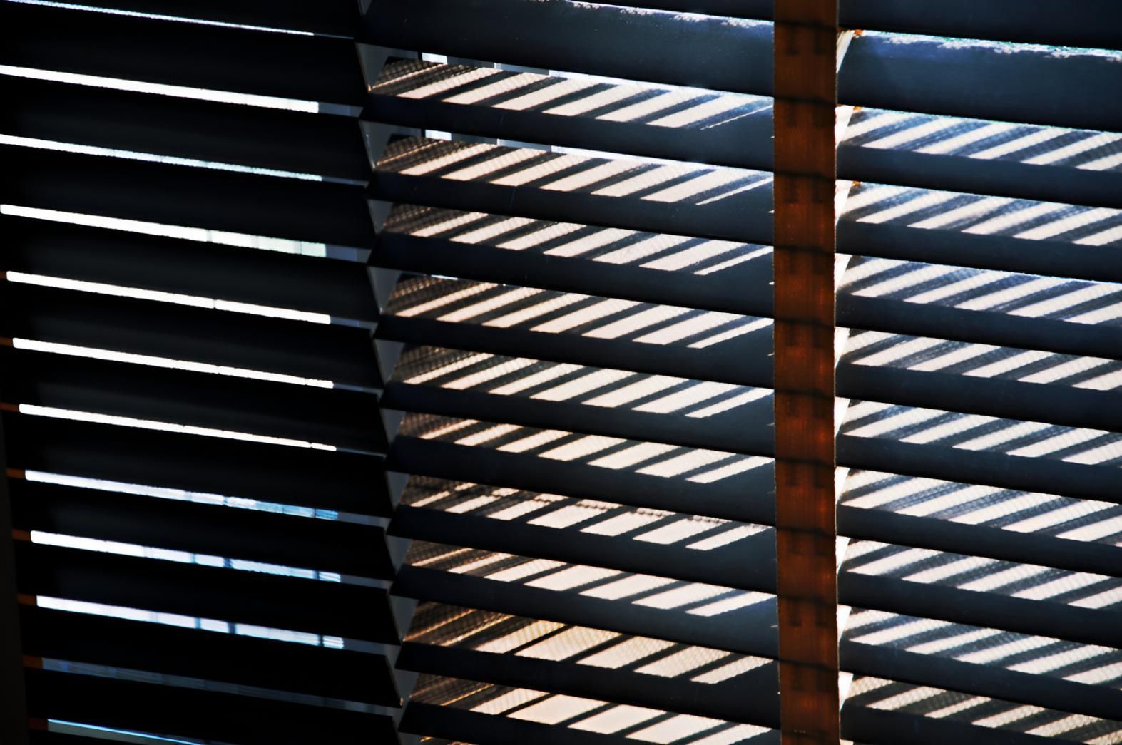 A Close Up of a Window With Blinds on It — A1 Security Screens Cairns In Manunda, QLD