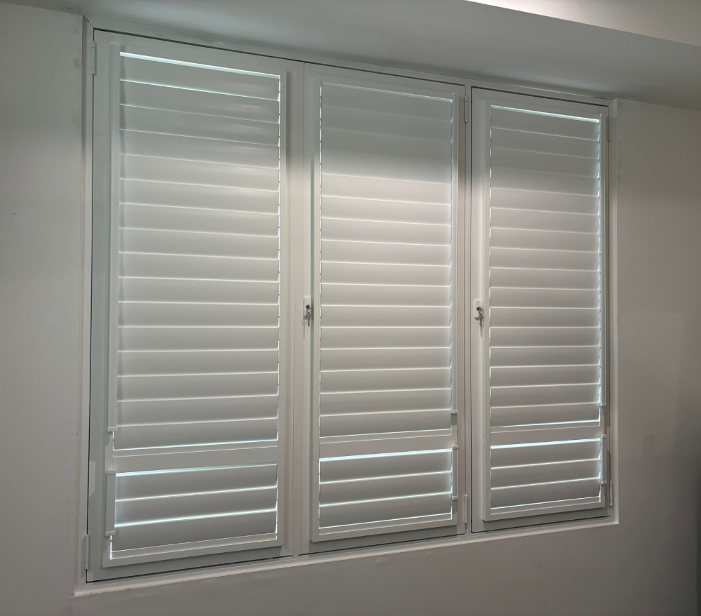 Three white shuttered windows set in a white wall.— A1 Security Screens Cairns In Manunda, QLD