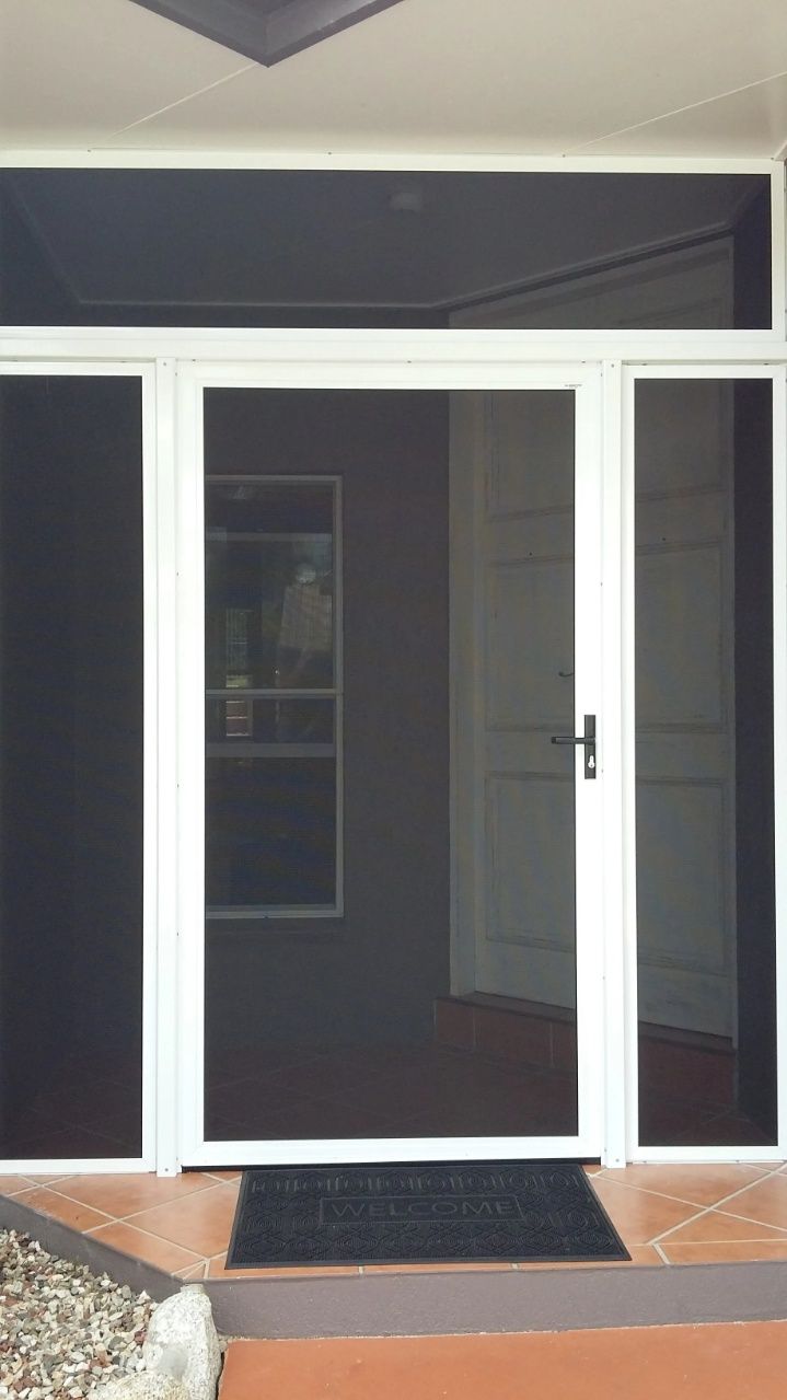 A White Screen Door With a Black Mat in Front of It — A1 Security Screens Cairns In Manunda, QLD