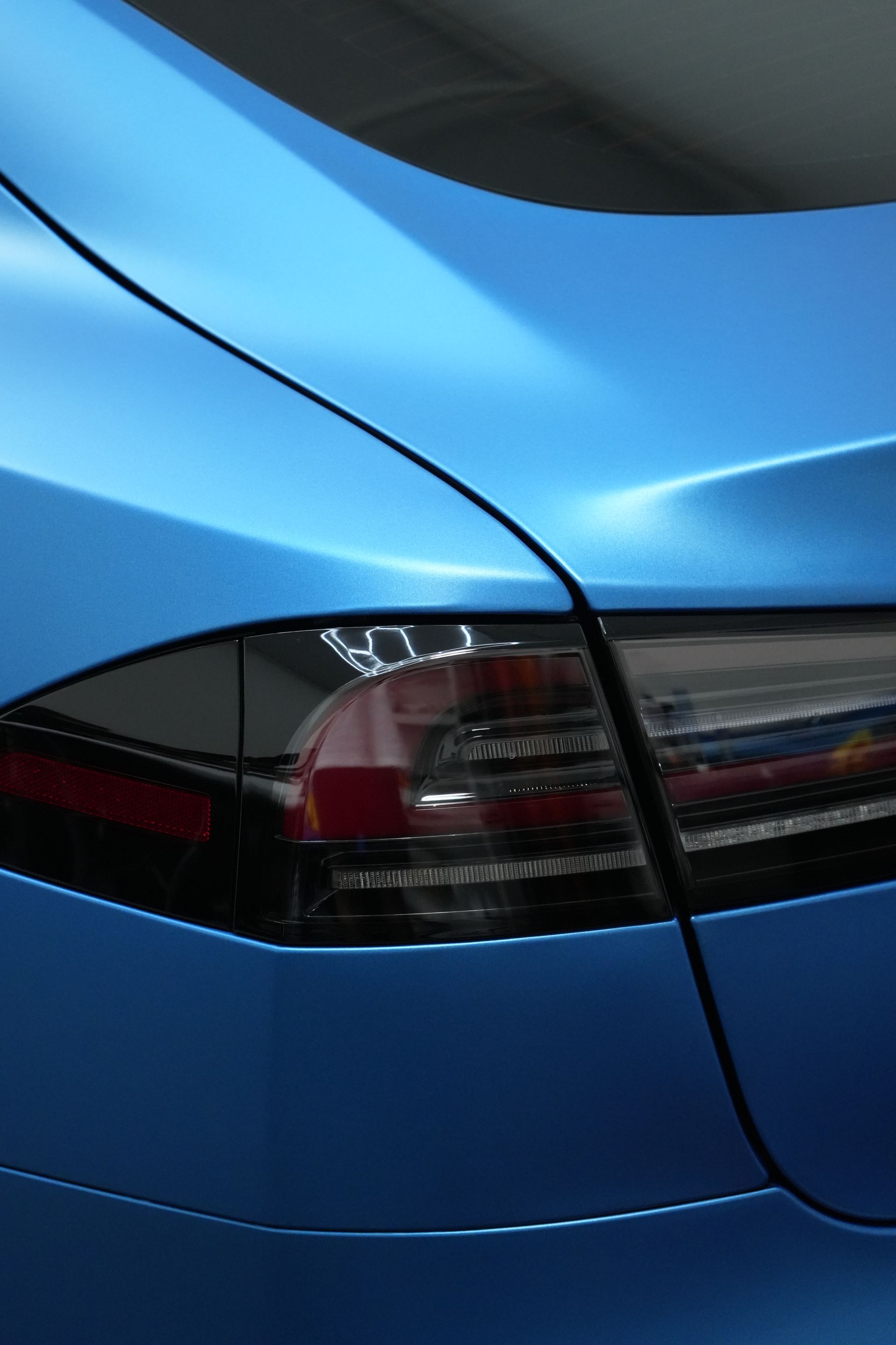 A close up of a blue car 's tail light