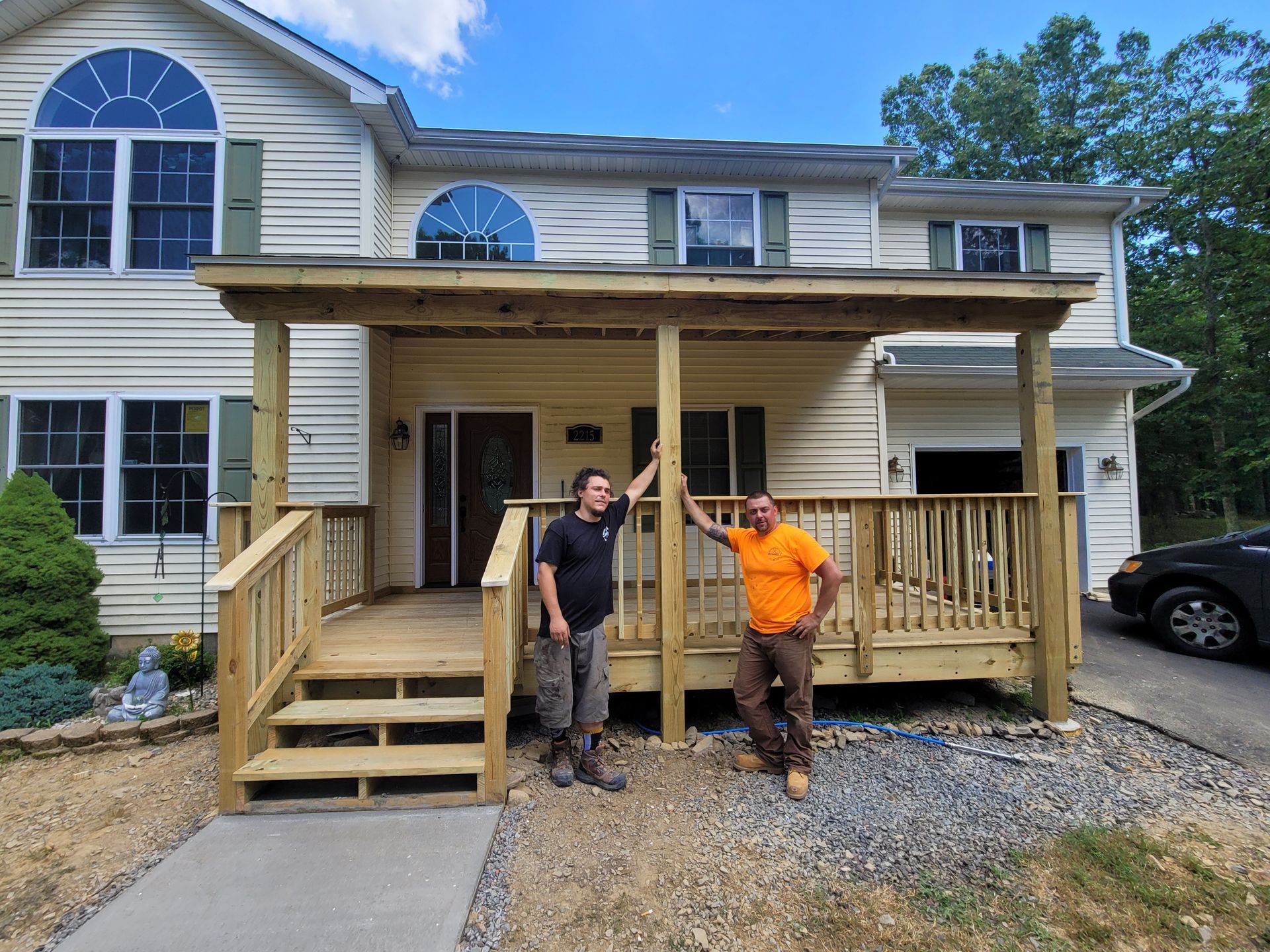 The Deck Dudes posing next to a completed project