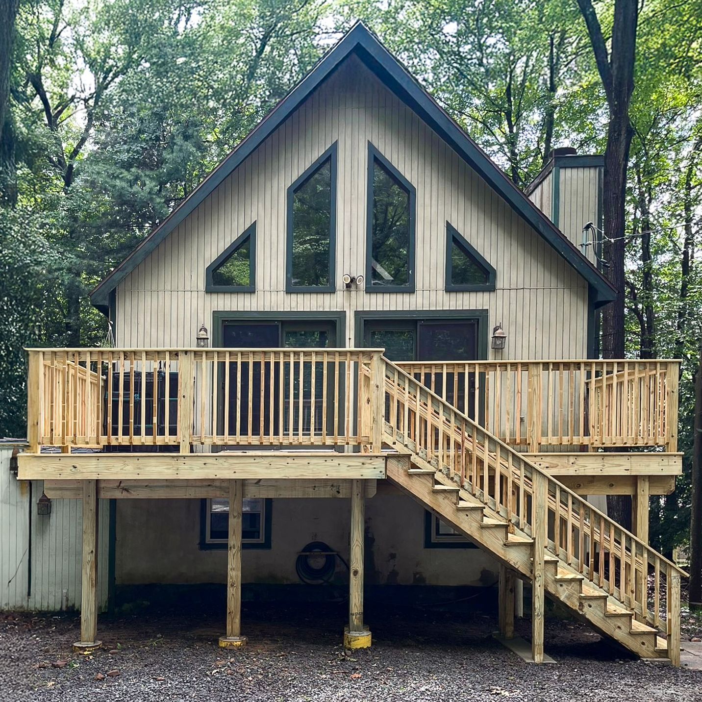 A house with a large deck and stairs leading up to it