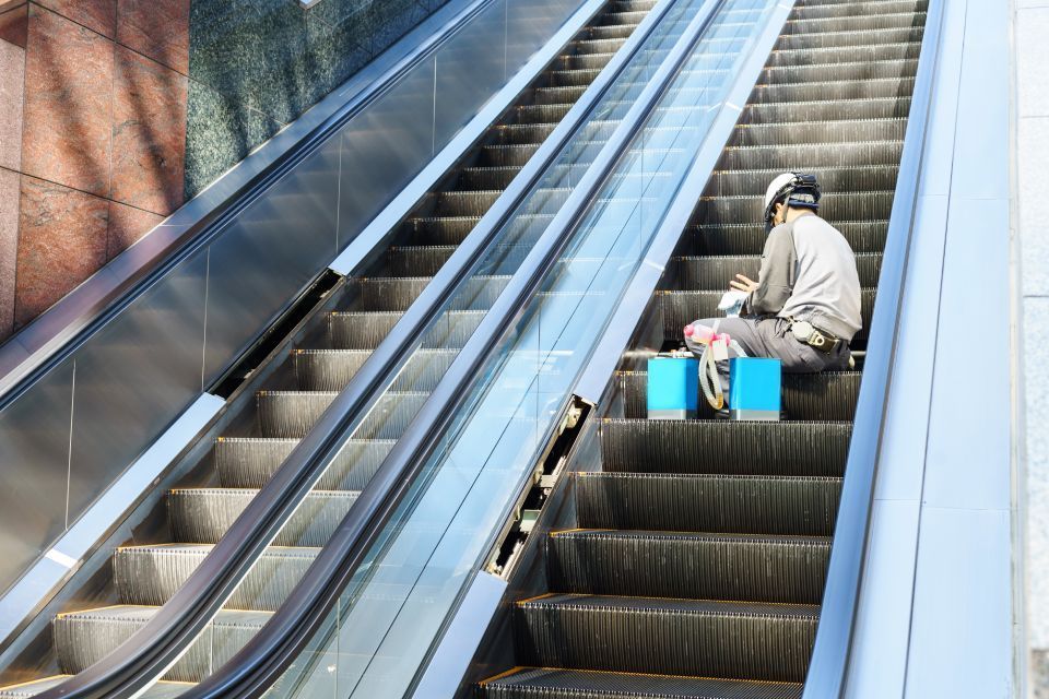 worker repairing  escalator